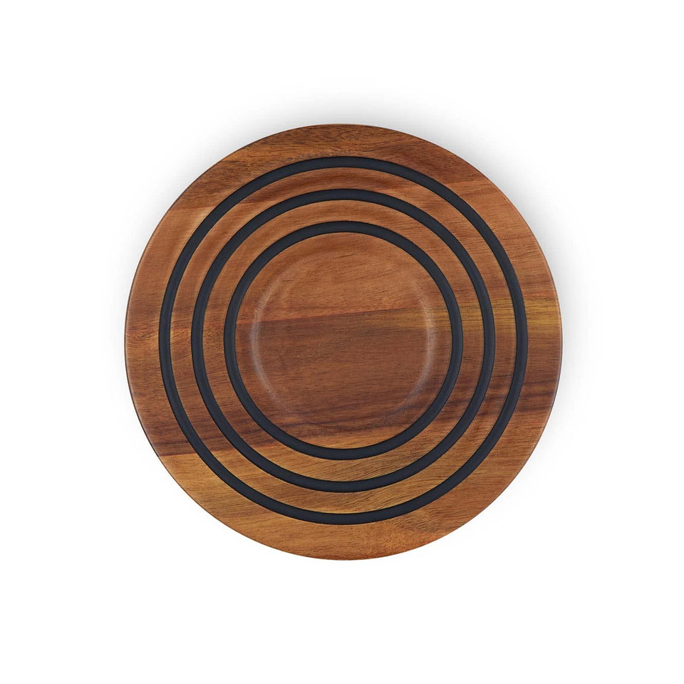 Le Creuset magnetic wooden trivet in acacia wood showing the magnet for oven-to-table use.
