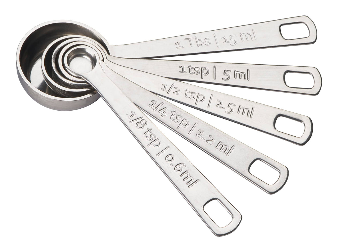Le Creuset measuring spoons set of 5 with polished finish for precise ingredient measurement.