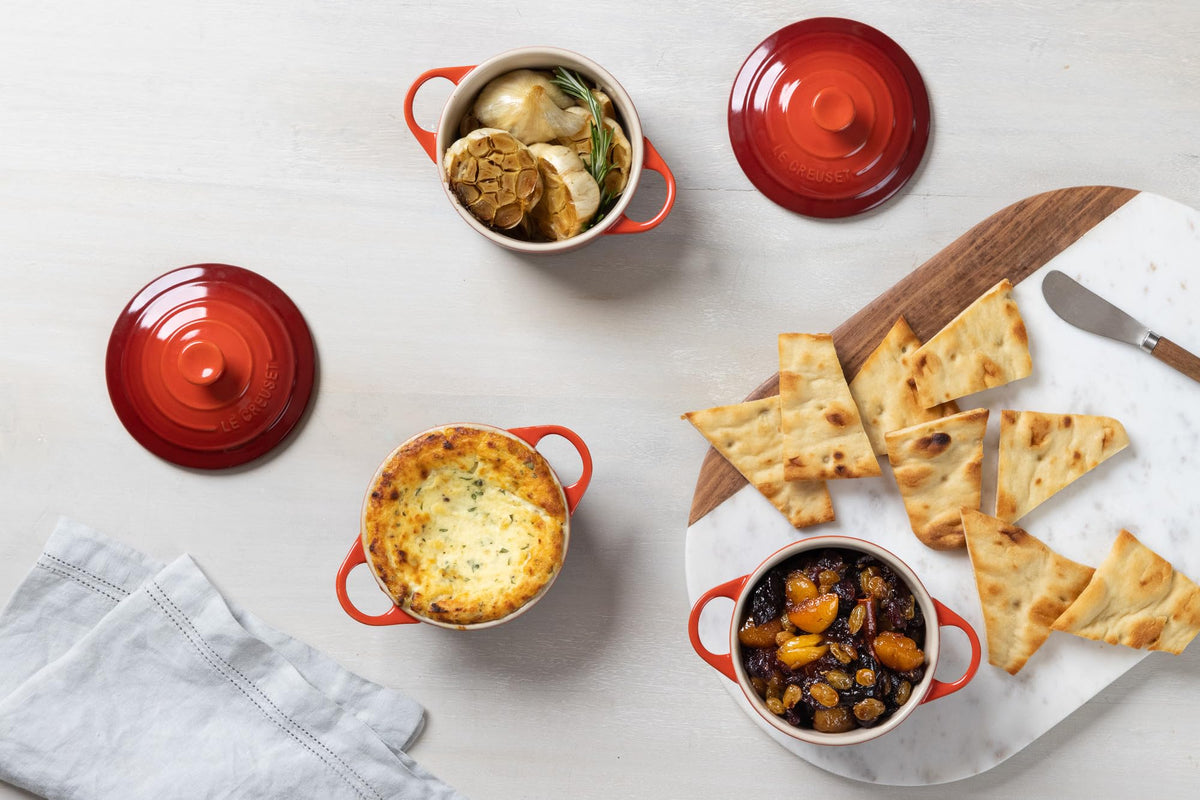 Le Creuset Cerise cocotte on countertop with vibrant glaze