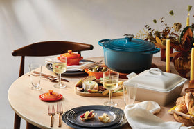 Le Creuset Mini Round Cocotte 8oz Flame, serving-ready with vibrant color.