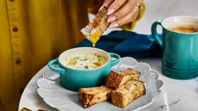 Le Creuset mini round cocotte Riviera on table showing vibrant color and heat retention.