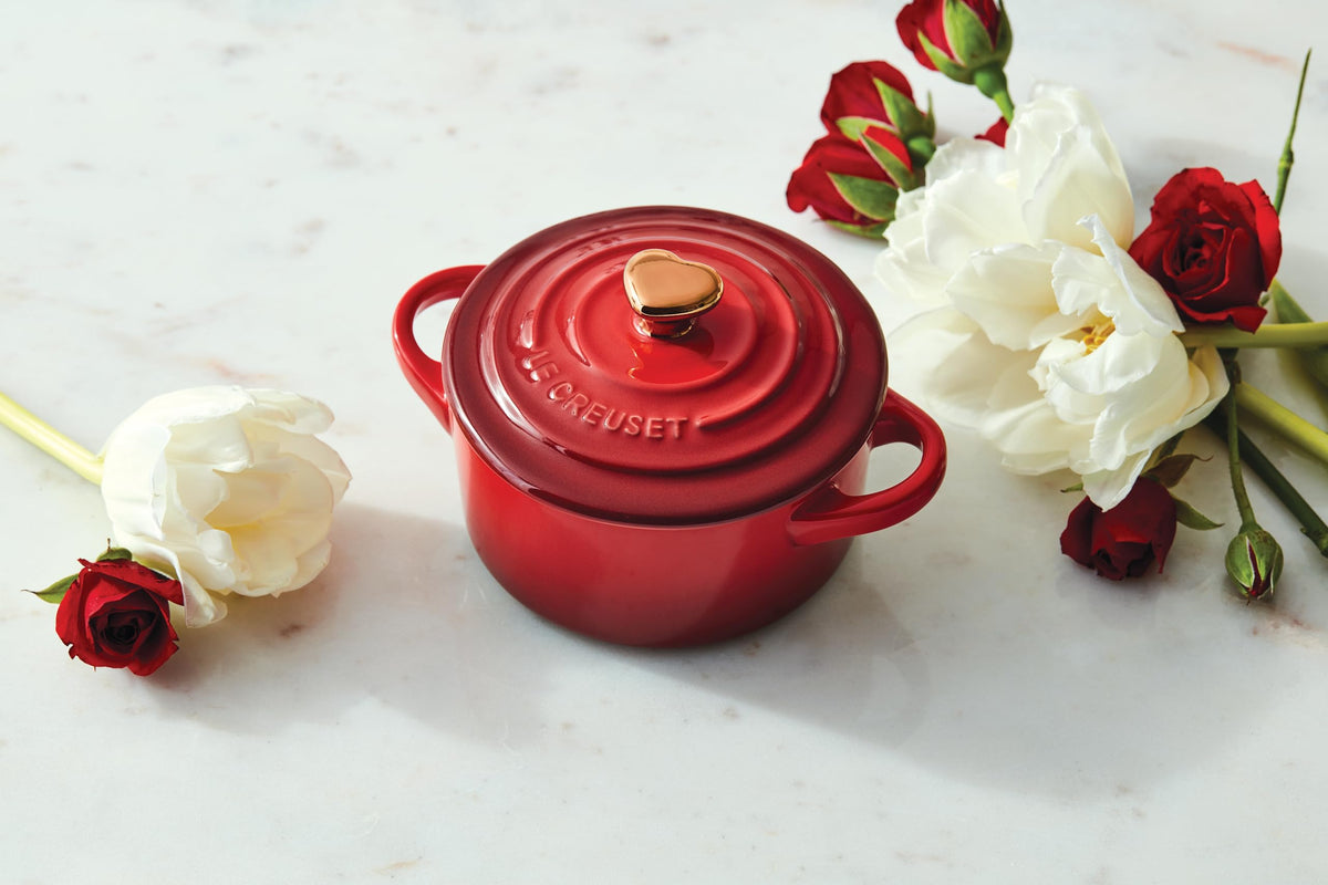Close-up of the gold heart knob on Le Creuset cocotte highlighting durable enamel.