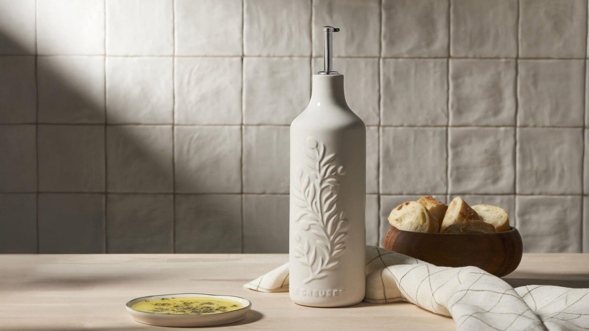 Le Creuset oil cruet with pour nozzle protects oils from light and heat during serving.