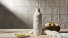 Le Creuset oil cruet with pour nozzle protects oils from light and heat during serving.