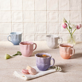 Le Creuset Petal Mug with embossed petal design, durable stoneware for hot beverages.