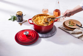 Ergonomic handles and stainless steel knob on Le Creuset Cerise Dutch oven
