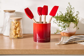 Le Creuset utensil crock with straight-wall design keeps utensils upright while cooking.