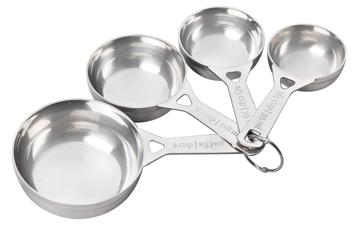 Le Creuset stainless steel measuring cups set of four for precise baking and cooking.