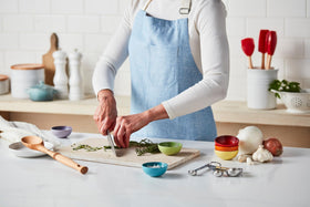 Le Creuset stoneware spoon rest shown beside utensils for quick cleanups.