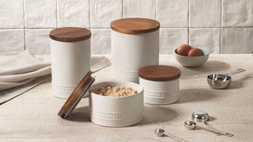 Le Creuset stackable storage canister with acacia lid and silicone gasket keeps contents airtight