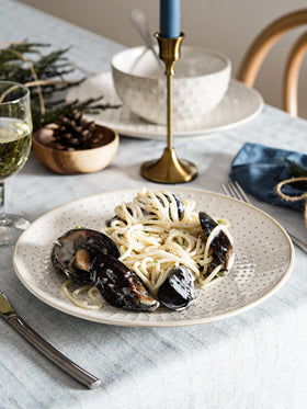 LE TAUCI white embossed dinner plate close-up showing elegant texture.
