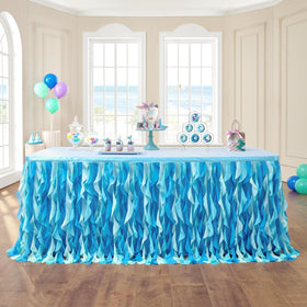Leegleri 6ft tulle table skirt in ocean blue over a rectangle table for a festive setup.