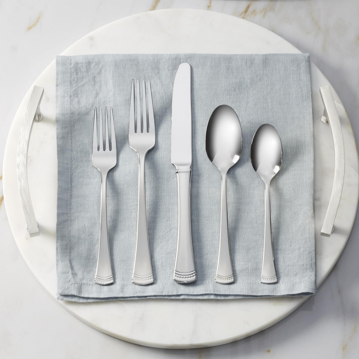 Lenox Portola 18/10 stainless steel with bright mirror shine and durability.
