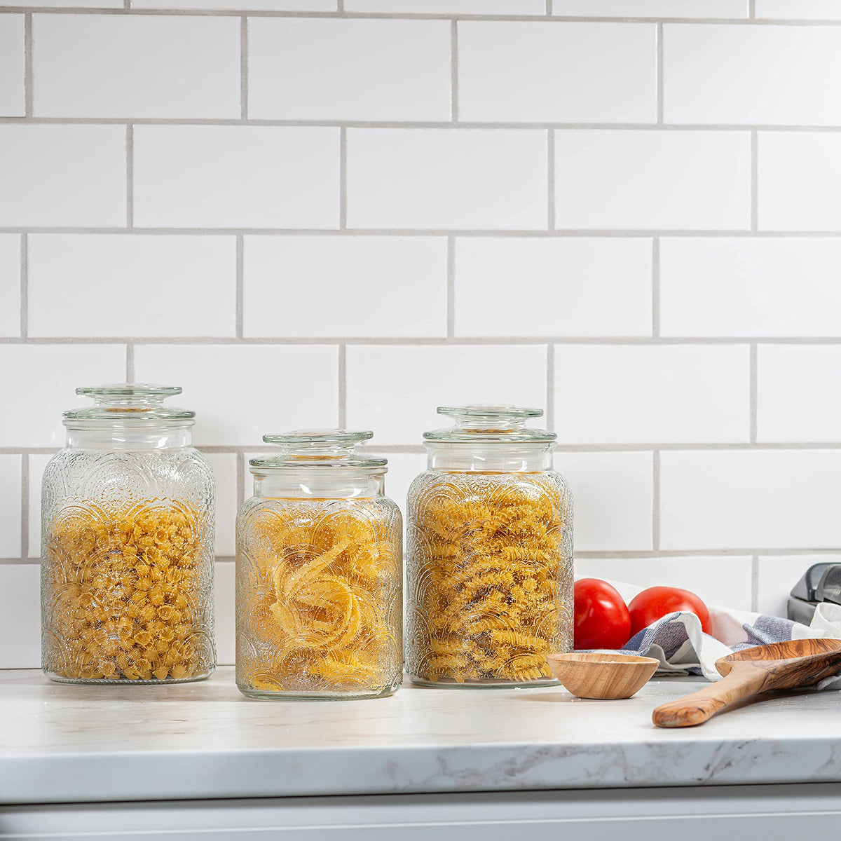 Le'raze 34 oz glass canister storing tea and sugar with easy access.