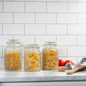 Le'raze 34 oz glass canister storing tea and sugar with easy access.