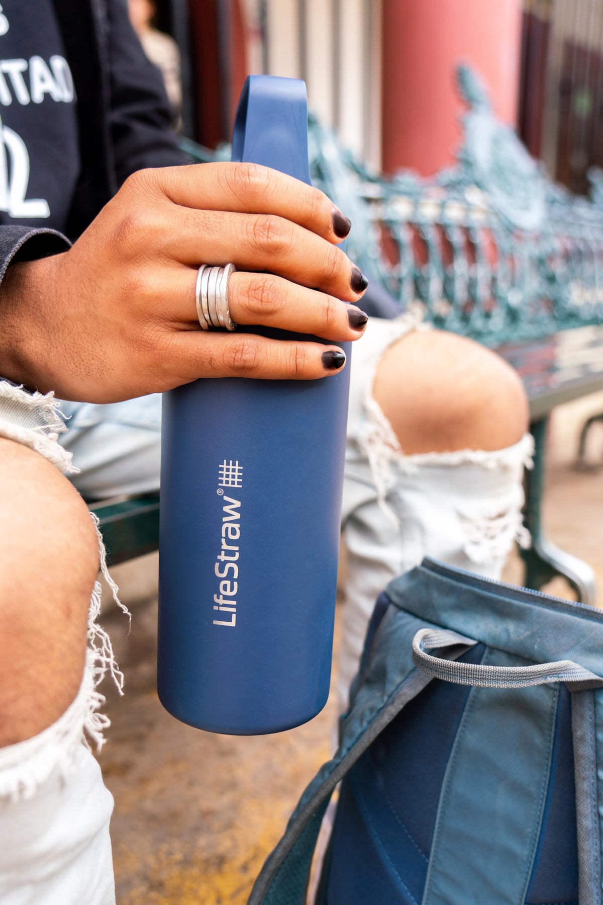 LifeStraw Go Series bottle in use during a hike for hydration on the trail
