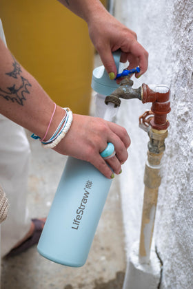 LifeStraw Go Series seafoam bottle in hand for on-the-go hydration.