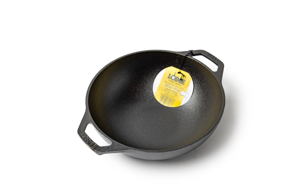 Lodge 9in mini wok with dual loop handles for easy lifting on the stovetop.