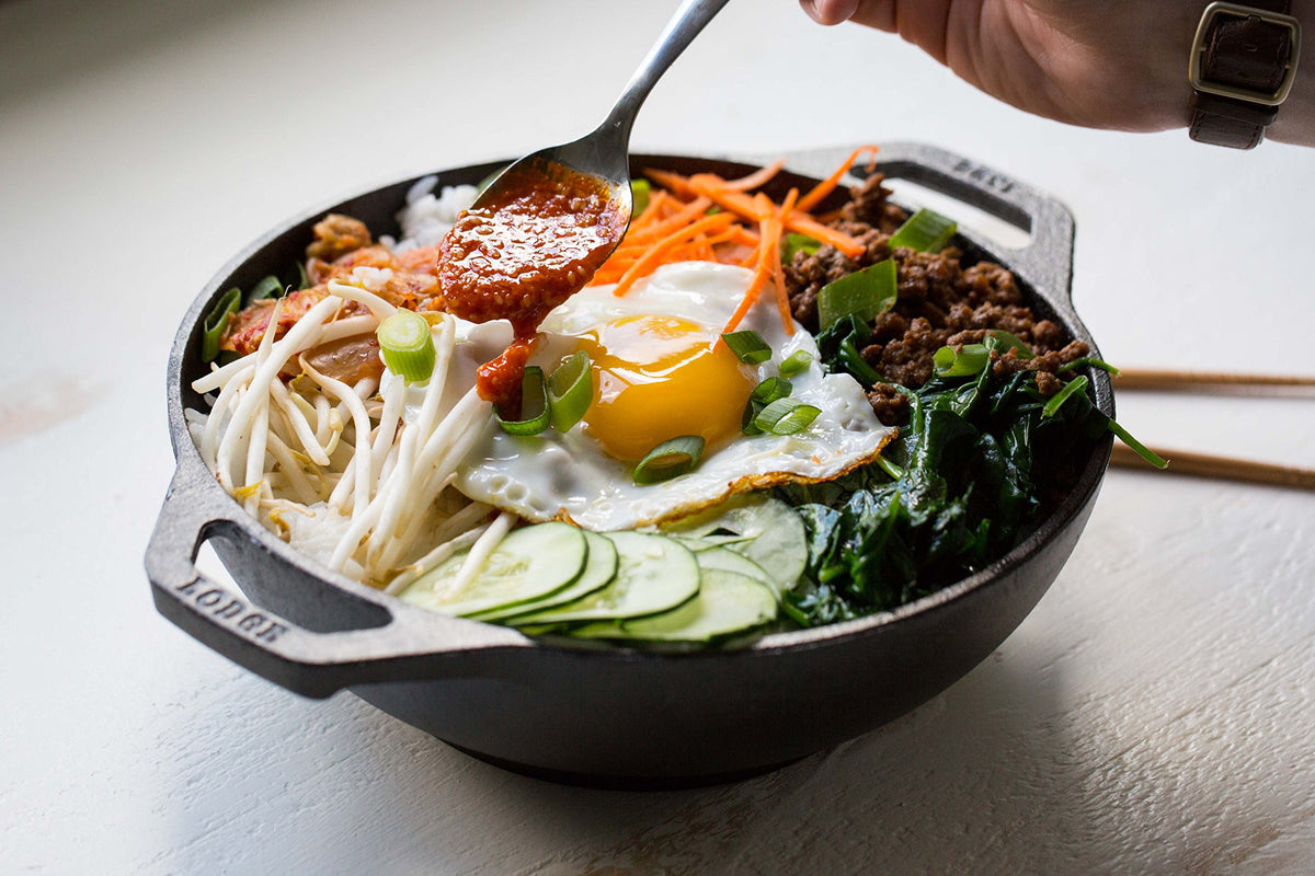 Lodge mini wok pre-seasoned with oil for natural non-stick performance.