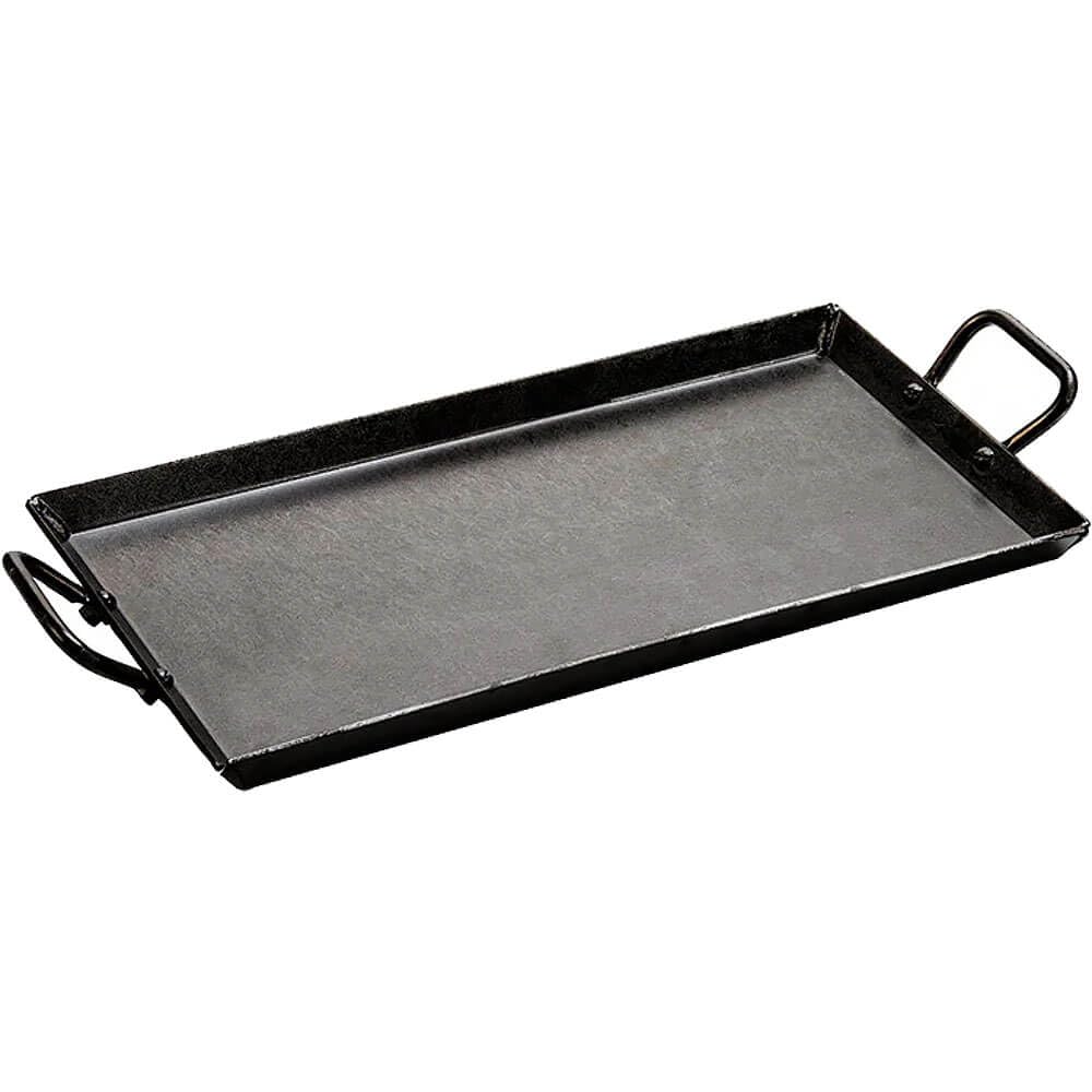Lodge carbon steel griddle in oven for even heating and versatile cooking