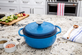 Lodge Caribbean Blue Dutch Oven served at table, ready to share a meal.