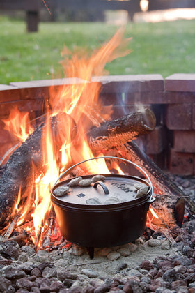 Lodge cast iron pot over hot coals delivering even heat and moisture retention.