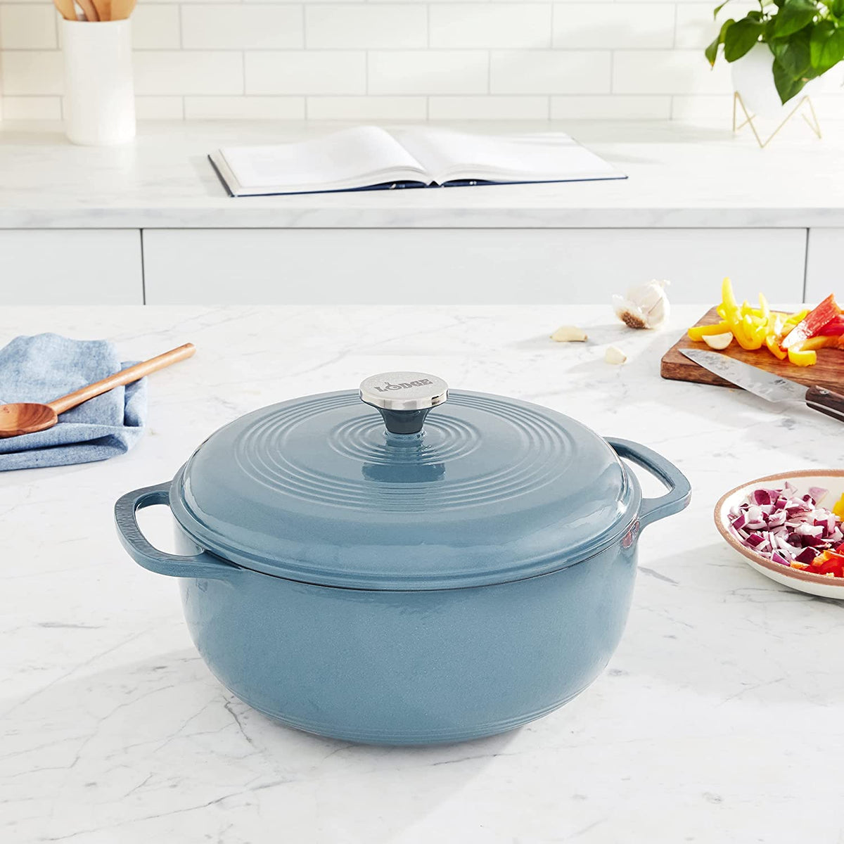 Lodge Dutch Oven Storm Blue in use with steady heat for cooking.
