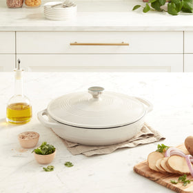Lodge enameled cast iron casserole on stove with dual handles