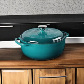Lodge Lagoon enamel Dutch oven on stovetop, versatile for marinating and cooking.