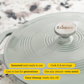 Lodge Essential Enamel Braiser with dual assist handles for secure transport.