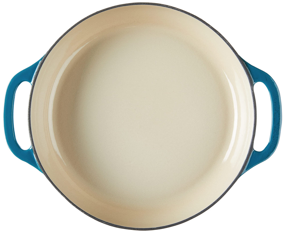 Lodge Essential Enamel Braiser on stove and oven, durable cast iron warmth for slow cooking.