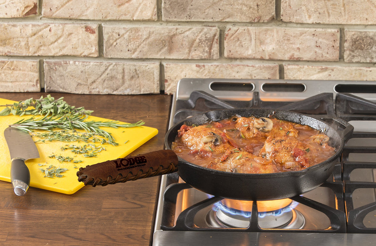 Lodge Nokona leather hot handle holder wrapped around a skillet for safe transport.