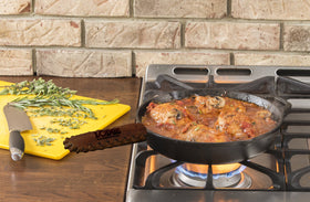 Lodge Nokona leather hot handle holder wrapped around a skillet for safe transport.