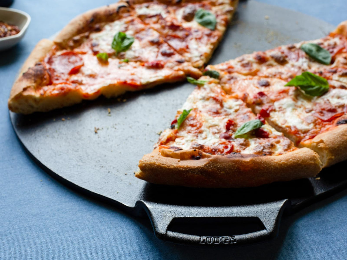 Lodge Seasoned Cast Iron Pizza Pan with dual assist handles for easy transfer