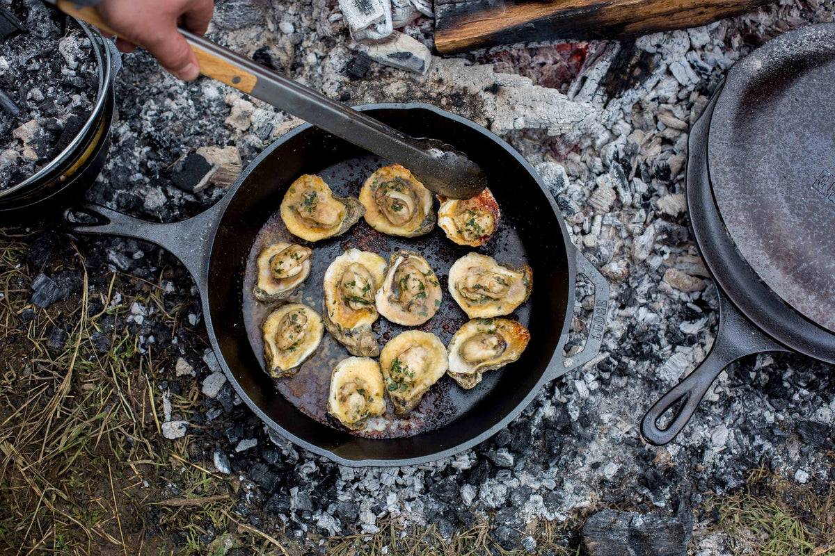 Lodge Seasoned Cast Iron Skillet handle close-up highlights sturdy teardrop grip.