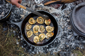 Lodge Seasoned Cast Iron Skillet handle close-up highlights sturdy teardrop grip.