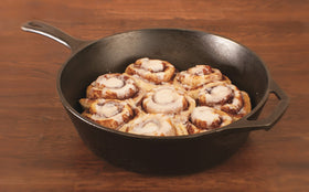 Lodge cast iron deep skillet shown across oven and grill for versatile meals