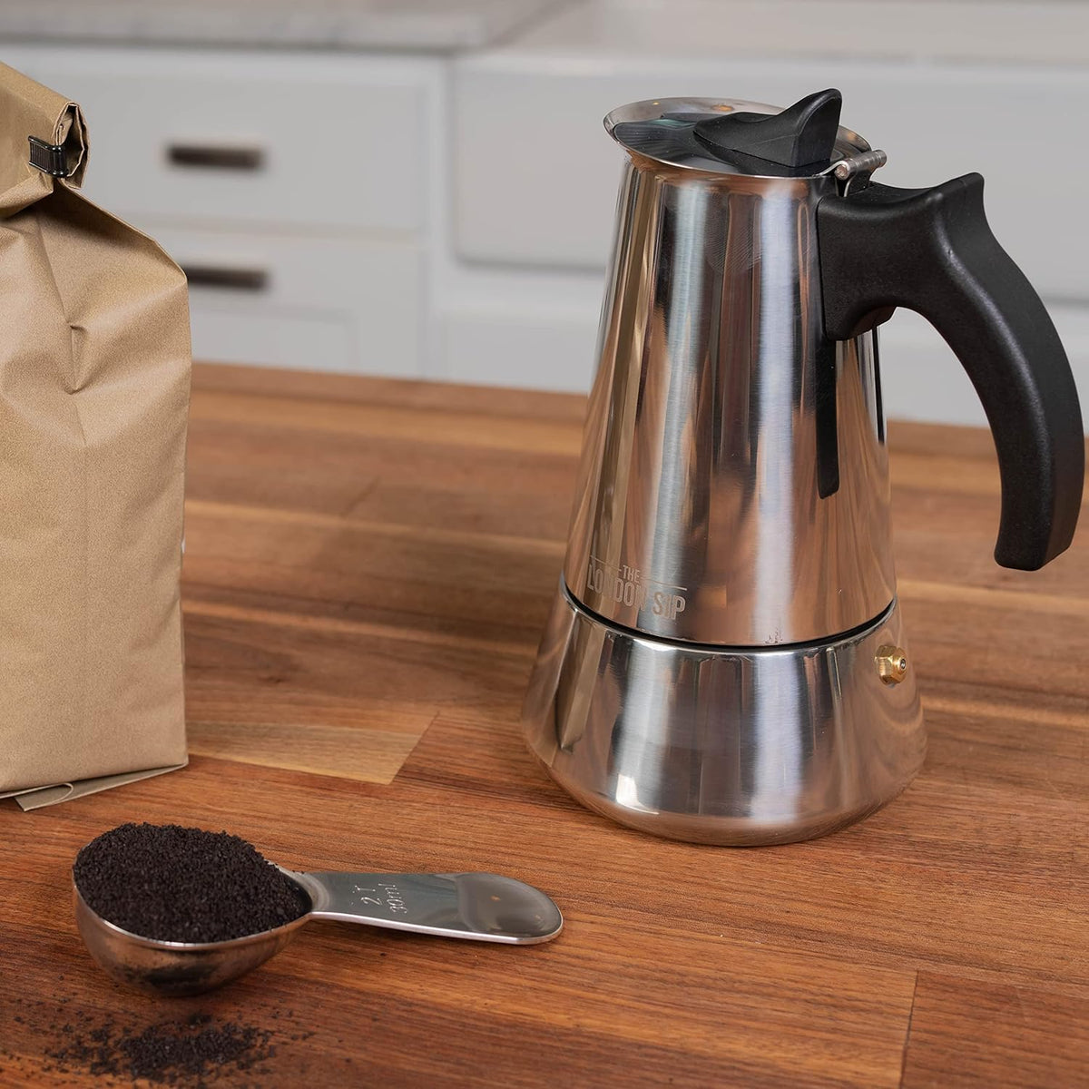 The London Sip moka pot handle closeup emphasizes heat-resistant grip for safe pouring
