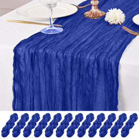 Lumaycens royal blue cheesecloth table runner draped on a table for a romantic wedding setting