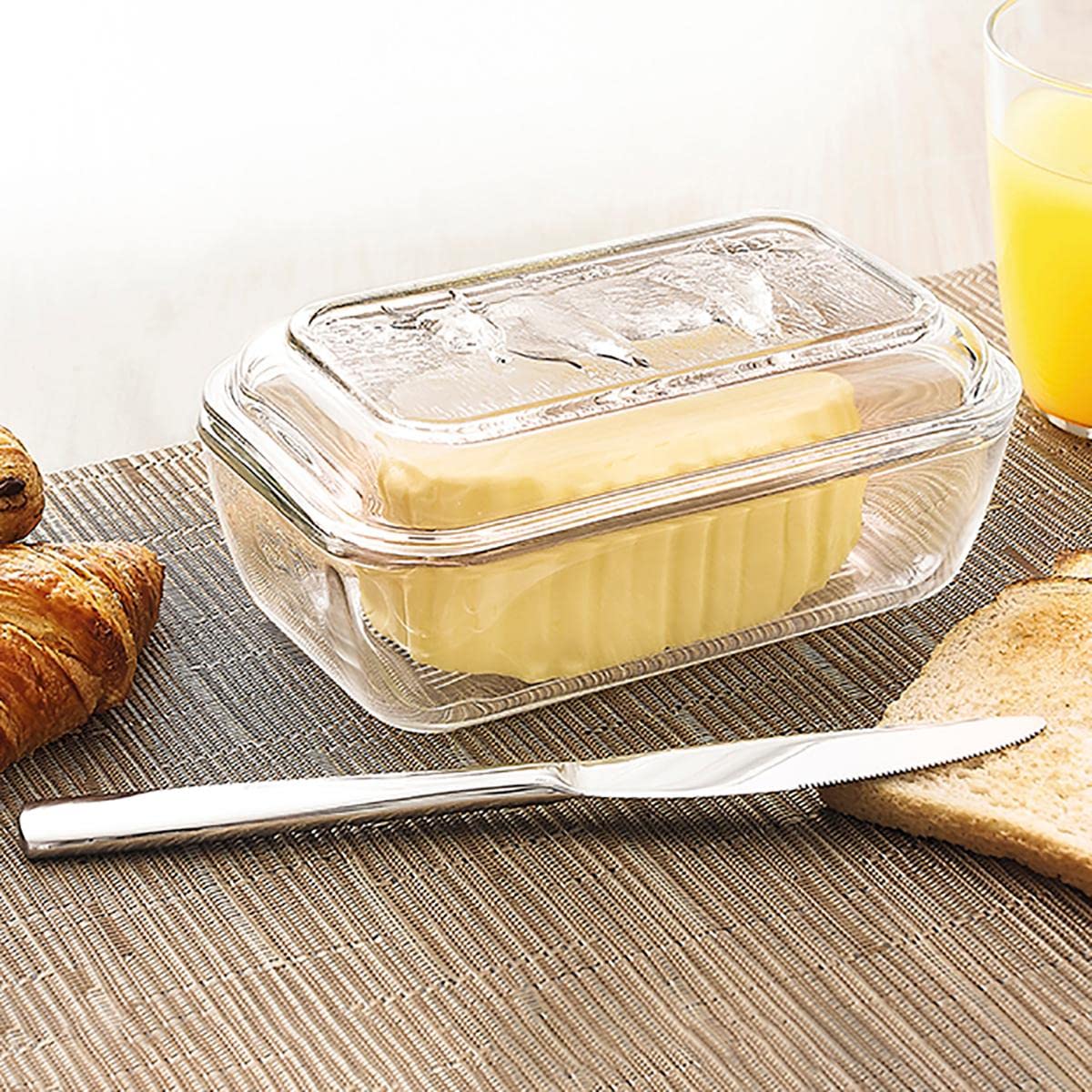 Luminarc cow butter dish rests on a bright kitchen counter.