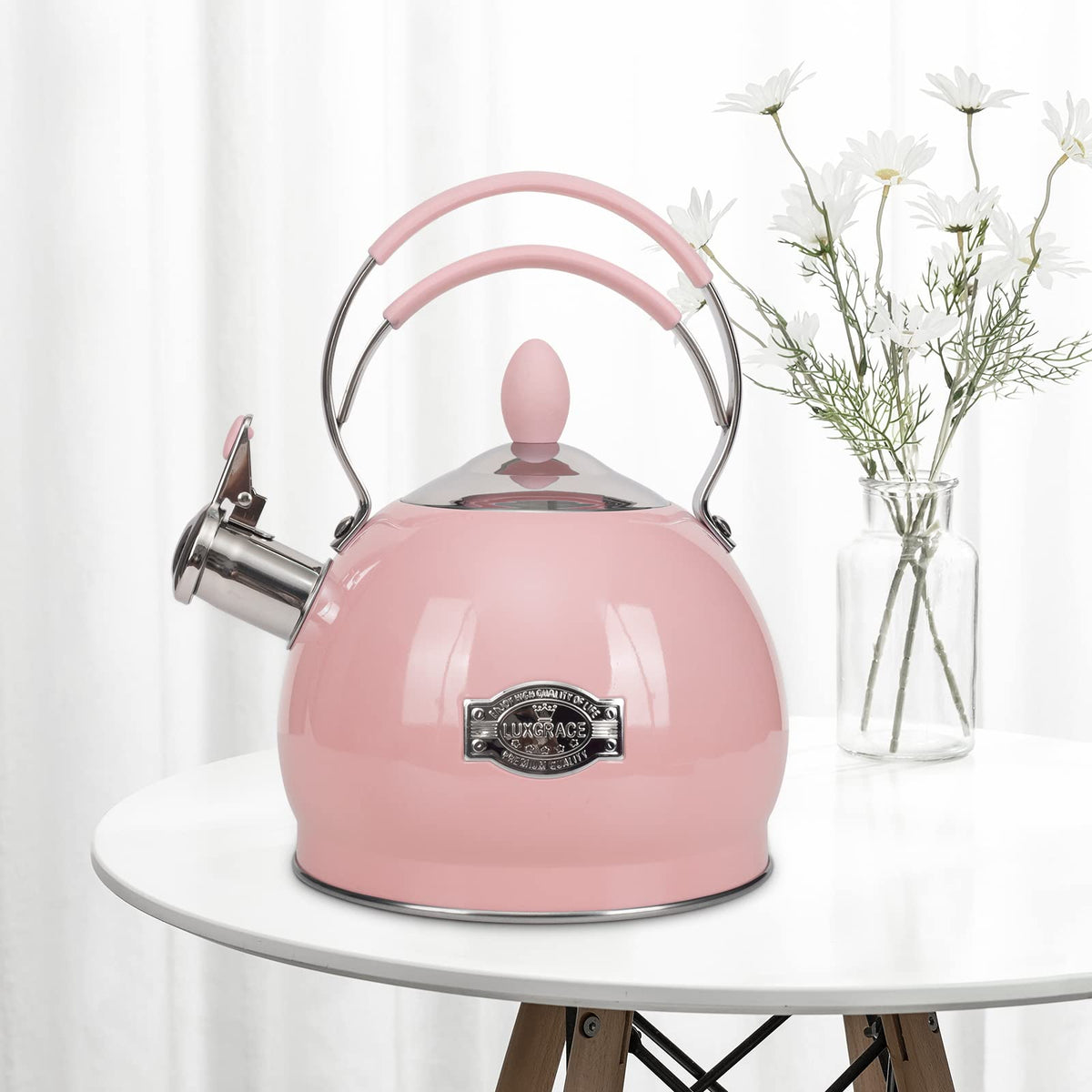 Luxgrace whistling kettle pouring spout with steam ready for tea.