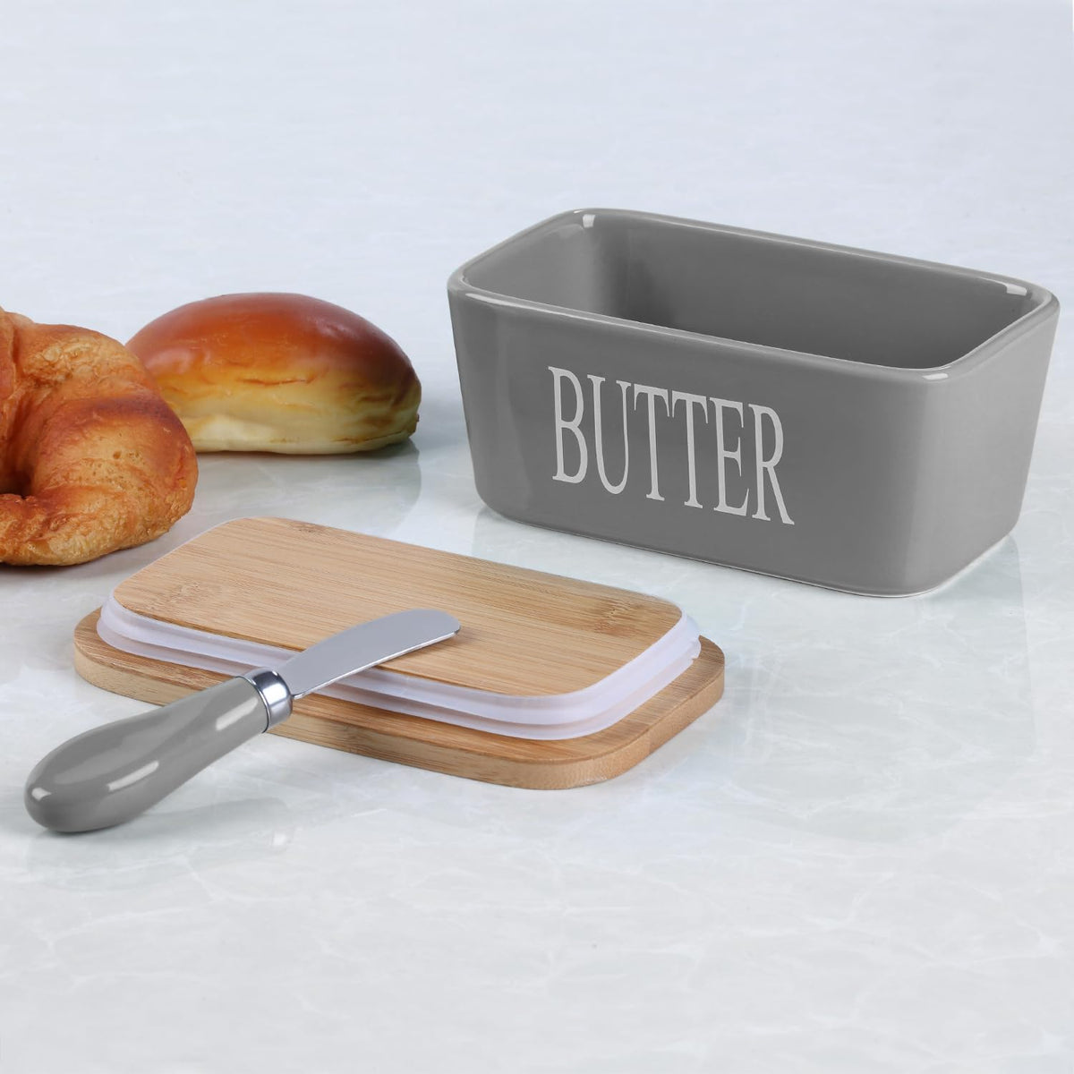 Lxmons butter dish on countertop enhances kitchen decor.