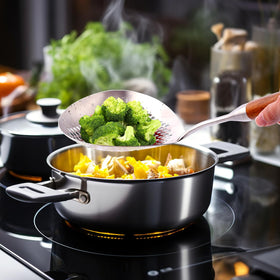 Hanging hole enables tidy storage in a compact kitchen.
