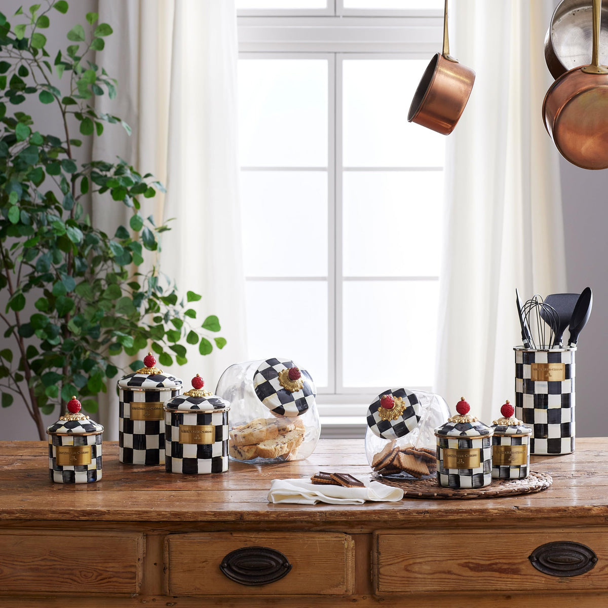 MacKenzie-Childs Courtly Check glass jar on the countertop showcases contents while elevating kitchen décor.