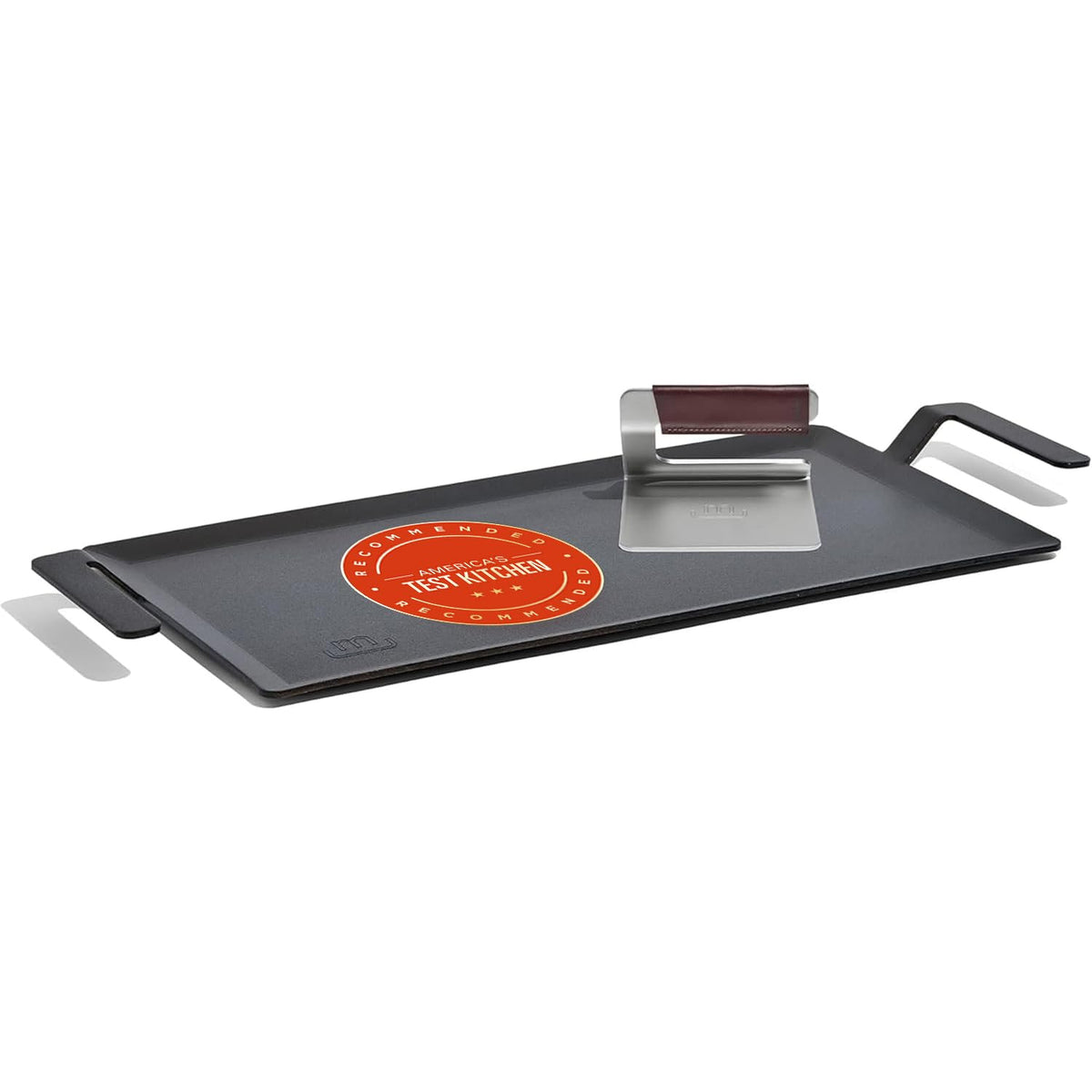 Made In carbon steel griddle searing surface for proteins and vegetables.