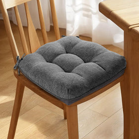 Magic Elephant cushions placed on a dining chair in a kitchen setup.