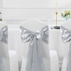 Manyshofu satin table runner tied on a chair back for decorative flair.