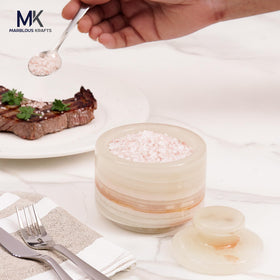 Marblous Krafts white onyx salt holder close-up showing natural veining and shine.