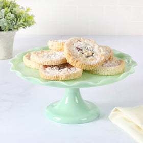 Martha Stewart Highbrook jadeite cake stand displaying cakes for a chic party centerpiece.
