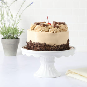 White pedestal cake stand with a footed base for stable dessert displays.